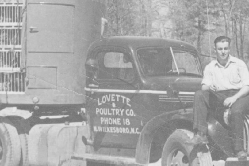 Wilkes Co man standing next to a Lovette Poultry Co truck